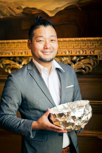 Silversmith Yusuke Yamamoto with his bowl, purchased for the Goldsmiths' Company Collection at the Fair in 2018. Photograph by Paul Read.