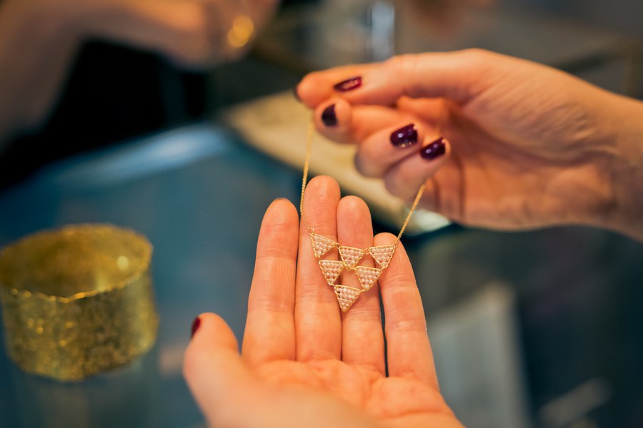 A Goldsmiths' Fair visitor with a gold and diamond necklace by Nina Bukvic. Photograph by Paul Read.